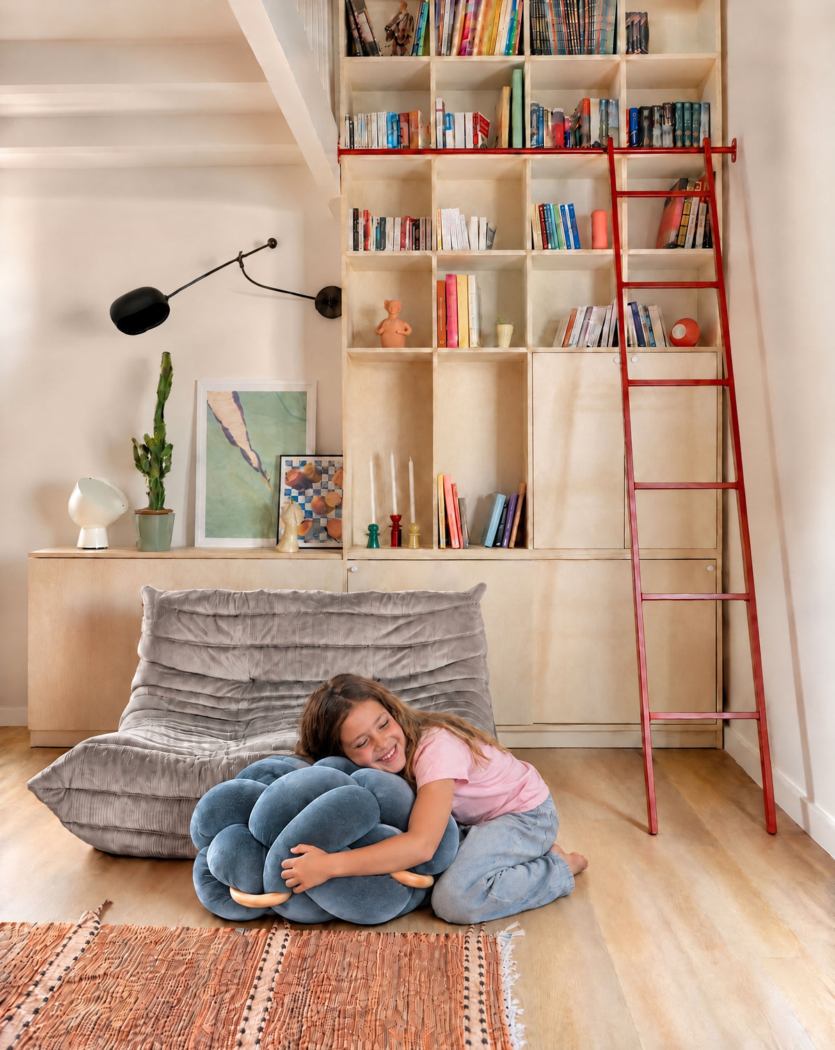 Girl hugging the (M) Ocean Blue Knot Ottoman