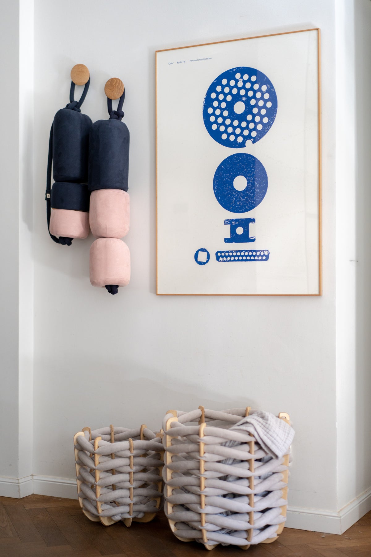 Diver's Buoy cushions hanging on a wall beside a framed poster