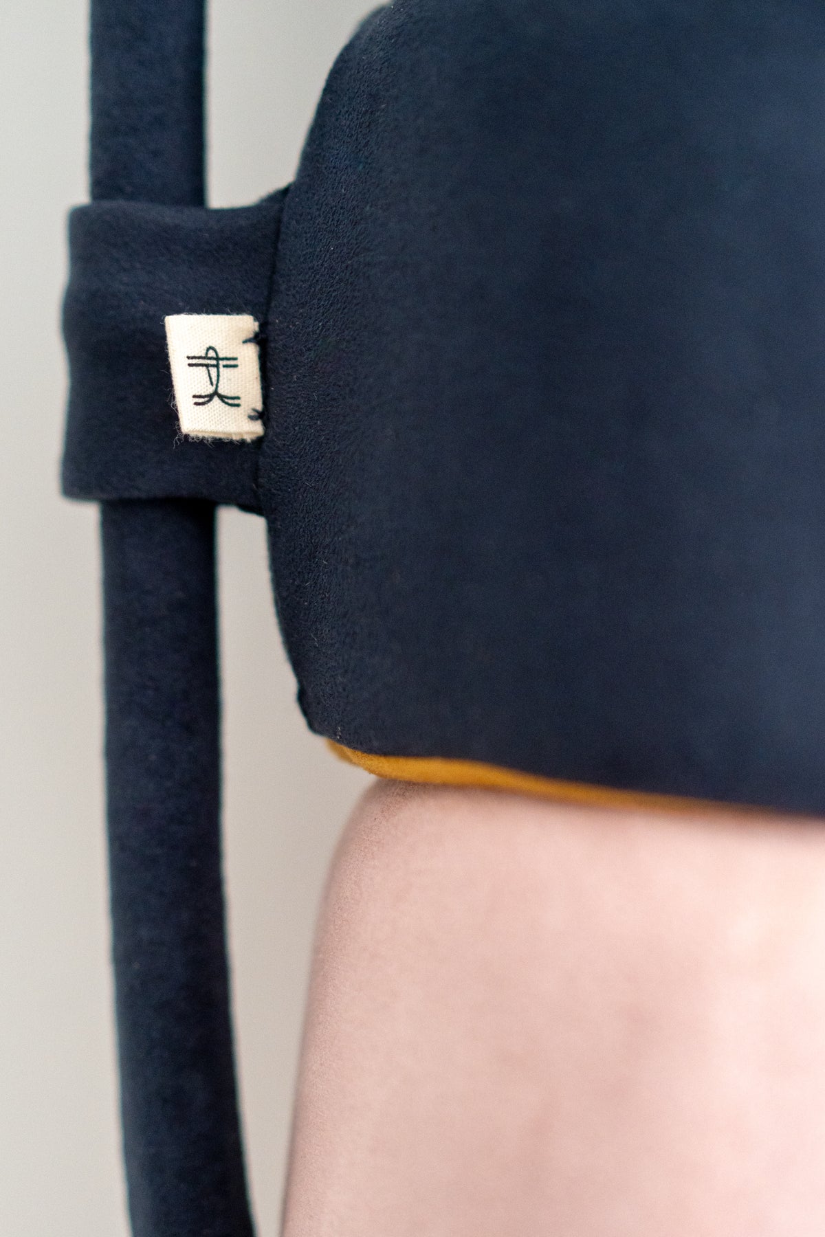 Close-up of navy vegan suede and stitching on a Diver's Buoy cushion