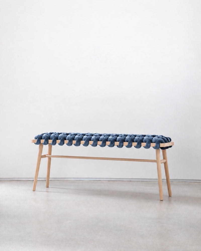 47 inch ocean blue velvet woven bench with a beechwood frame against a white wall