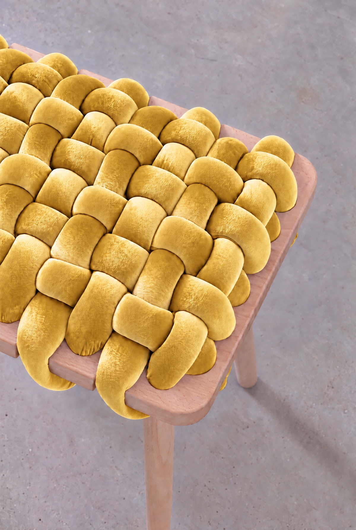 Close-up of the mustard yellow velvet weave on the woven bench's beechwood frame