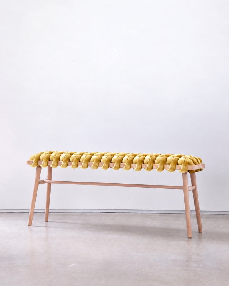 47 inch mustard yellow velvet woven bench with a beechwood frame against a white wall