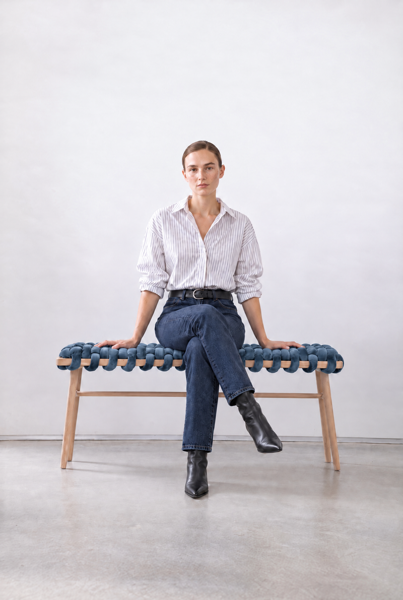 Woman sitting on a 47 inch ocean blue velvet woven bench