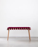 Burgundy velvet woven bench with a beechwood frame on a white background