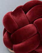 Close-up of smooth maroon velvet knot braids
