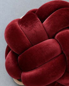 Close-up of smooth maroon velvet knot braids