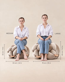 Model seated on Medium and Large Knot Ottomans to show scale