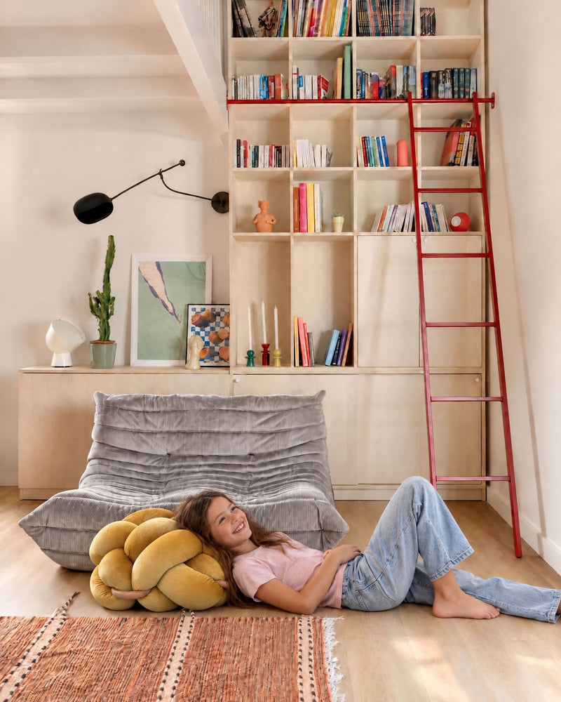 Girl leaning on the (M) Sunlight Yellow Knot Ottoman