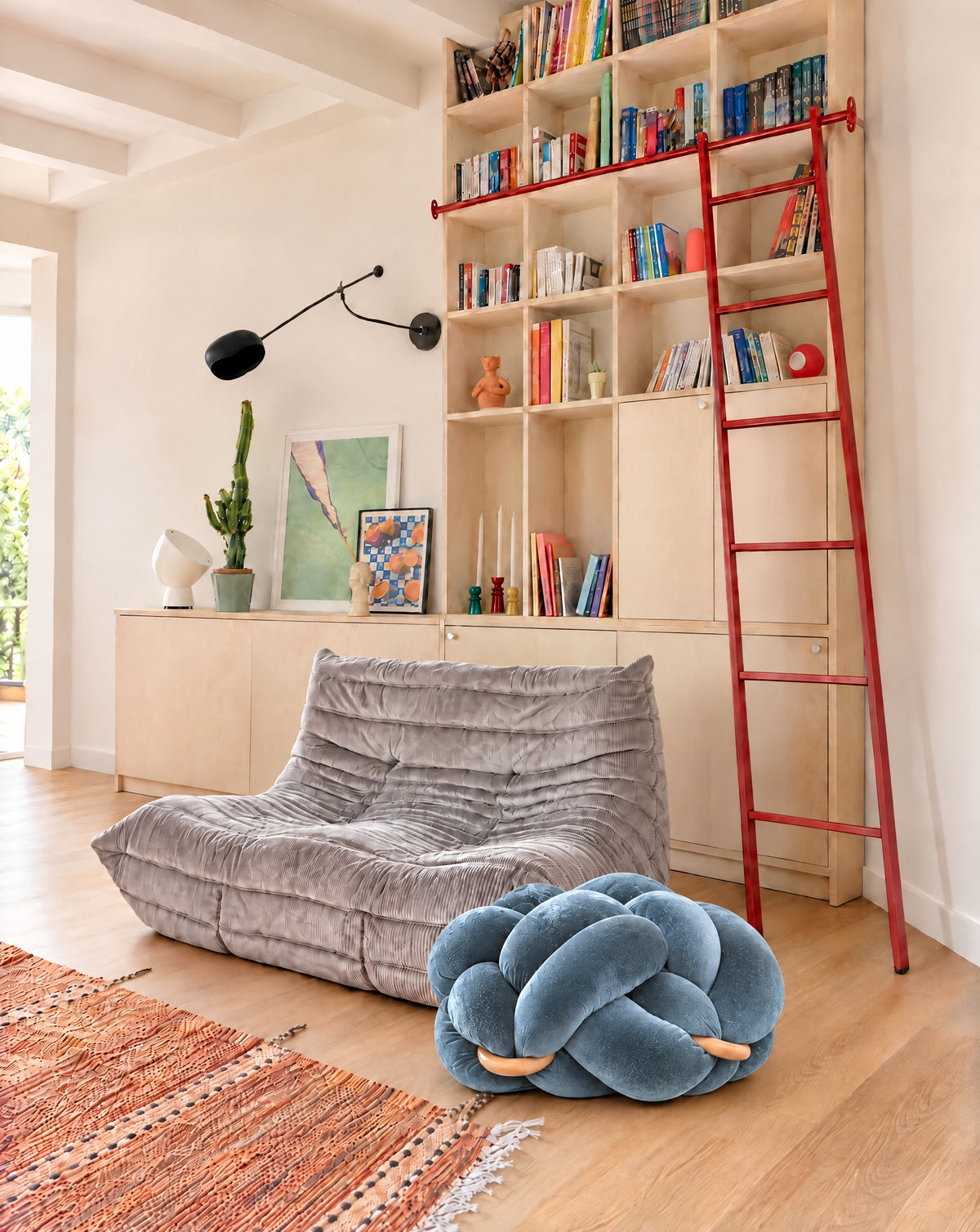 (M) Ocean Blue Knot Ottoman in a living room, side view