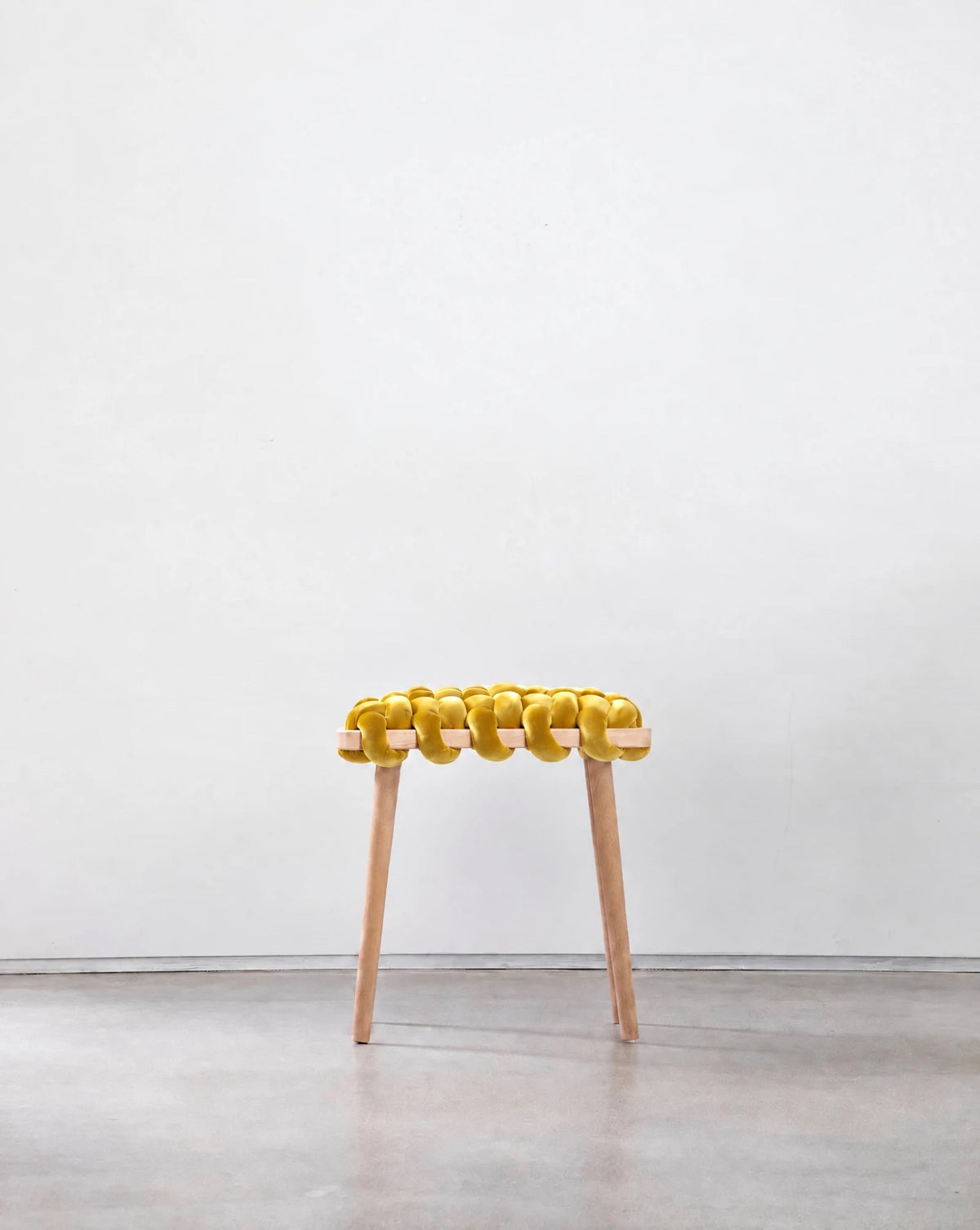 Mustard yellow velvet woven stool with a beechwood frame, front view